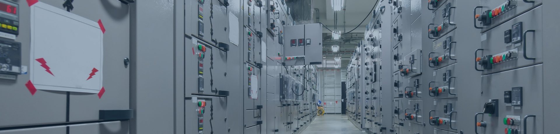 Industrial control room with operators monitoring SCADA systems on large screens, showcasing the critical OT environment where vulnerability management ensures operational continuity.